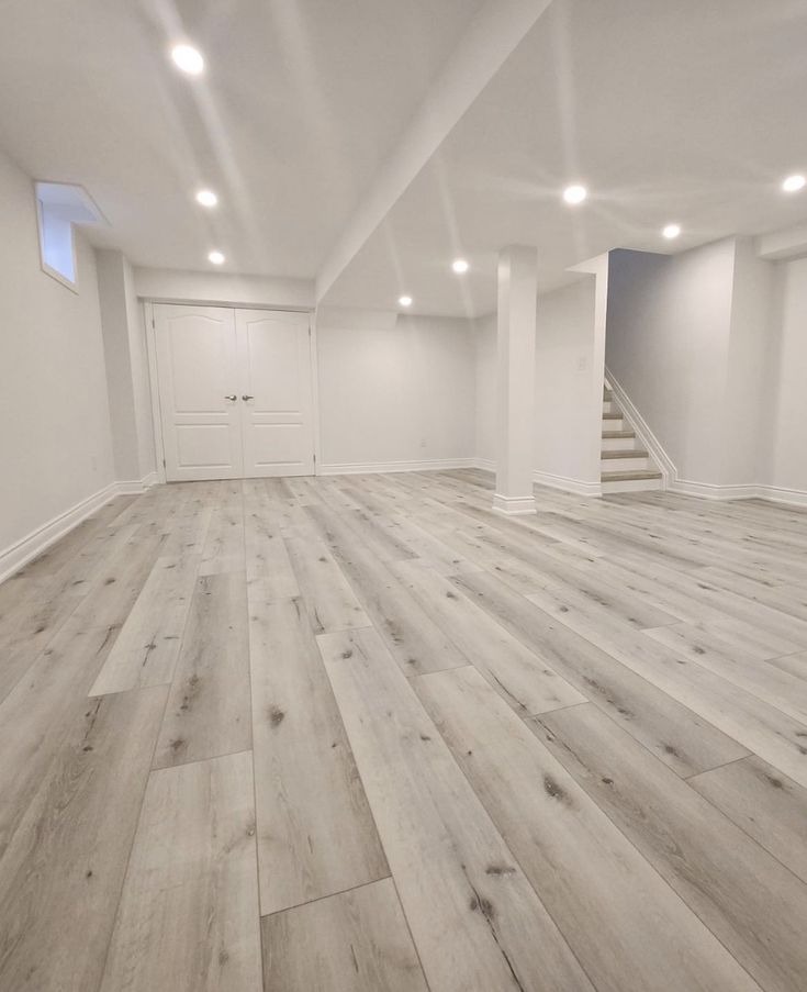 Luxury vinyl plank installation across finished basement and stairs